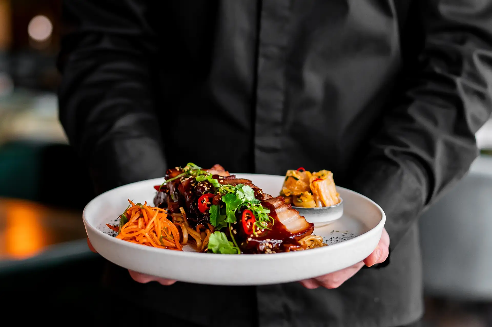 Chef holding dish